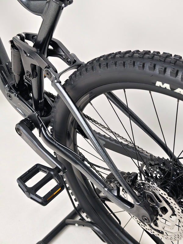 Performance shot of the Giant Stance 29 2 mountain bike navigating rough terrain.