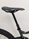 Image focused on the saddle area of the Giant Stance 29 2 with dropper post mechanism.