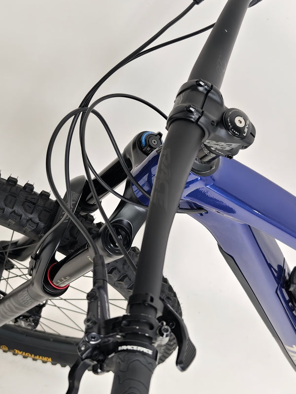 Trek Fuel EX 7 2024 Gen 6 (upgraded), M-L in Very Good Condition - picture of the bike beside a trail.