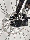 Register close-up of SRAM hydraulic brakes on the Transition Smuggler NX 2024 in medium, ensuring safe rides.