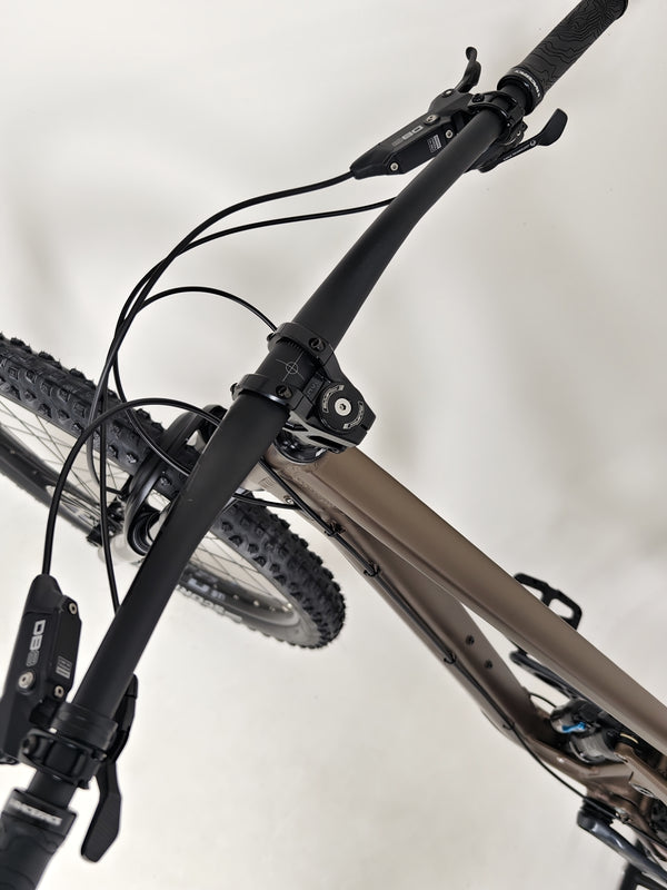 The Transition Smuggler NX 2024 in medium, expertly painted in espresso and shining under natural light.