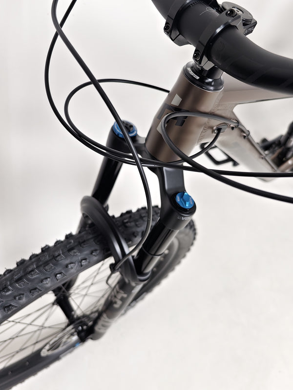 View focusing on wheel details of the Transition Smuggler NX 2024 in medium, featuring WTB STi30 rims.