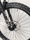 Front view with focus on front wheel and suspension of the Transition Smuggler NX 2024 in medium.