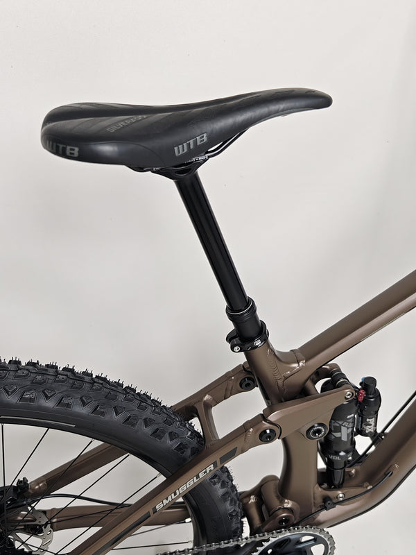 Dynamic view of the Transition Smuggler NX 2024 in medium as it navigates off-road terrain.