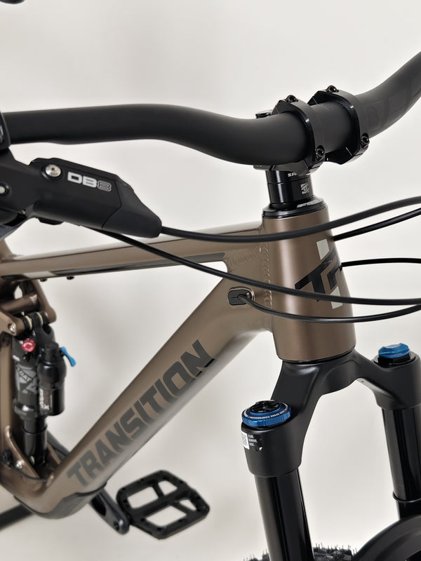 The Transition Smuggler NX 2024 in medium parked on the trails, illustrating its suitability for mountain biking.