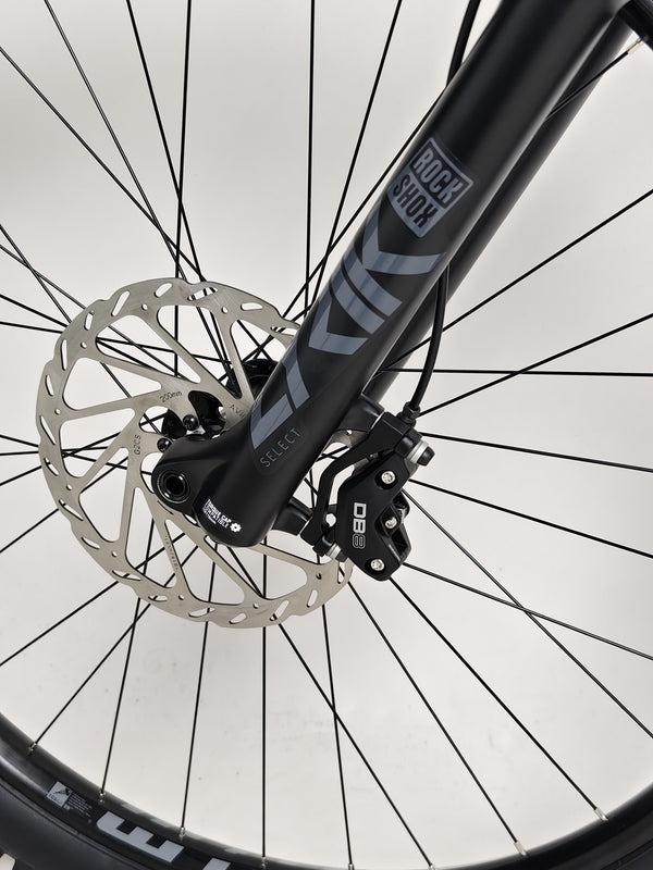 Nukeproof Mega 290 CARBON - Front view of the bike on a scenic overlook.