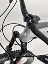 Nukeproof Mega 290 CARBON - Detailed view of front suspension setup on rugged terrain.