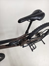 The Orange ALPINE 6 Full Suspension Mountain Bike in action on a rugged trail.