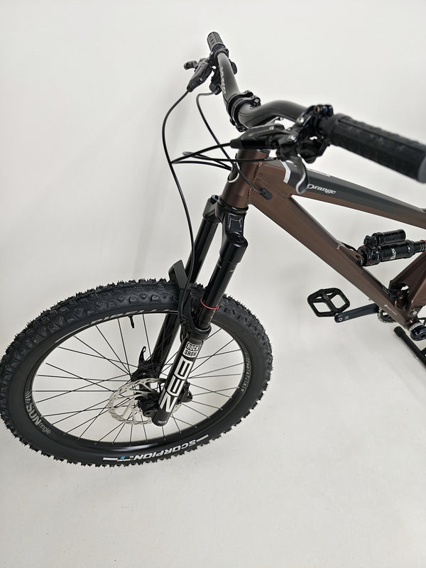Final close-up view of the suspension setup on the Orange ALPINE 6 mountain bike.