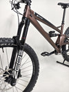 Rider on the Orange ALPINE 6 Full Suspension Mountain Bike on a scenic mountain trail.