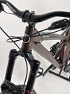 Professional cyclist handling the Orange ALPINE 6 mountain bike during a climb.