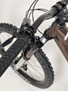 The Orange ALPINE 6 mountain bike resting in a picturesque field, ready for another ride.