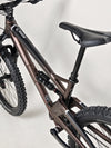 The Orange ALPINE 6 Full Suspension Mountain Bike displayed against a sunset.