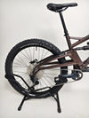 Close-up of the rear suspension and brake system on the Orange ALPINE 6 mountain bike.