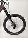 Dynamic shot of a biker riding the Orange ALPINE 6 mountain bike down a steep hill.