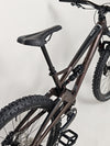 The Orange ALPINE 6 mountain bike's components carefully arranged on a workbench.