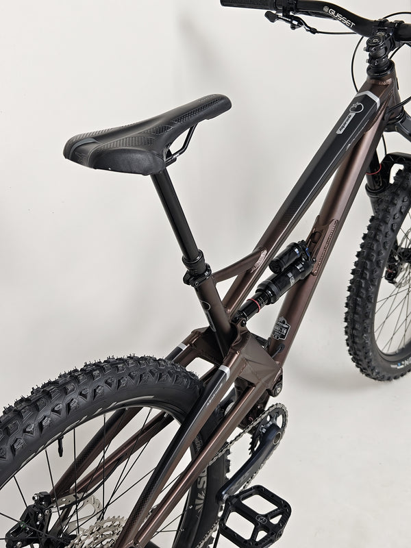 The Orange ALPINE 6 mountain bike's components carefully arranged on a workbench.