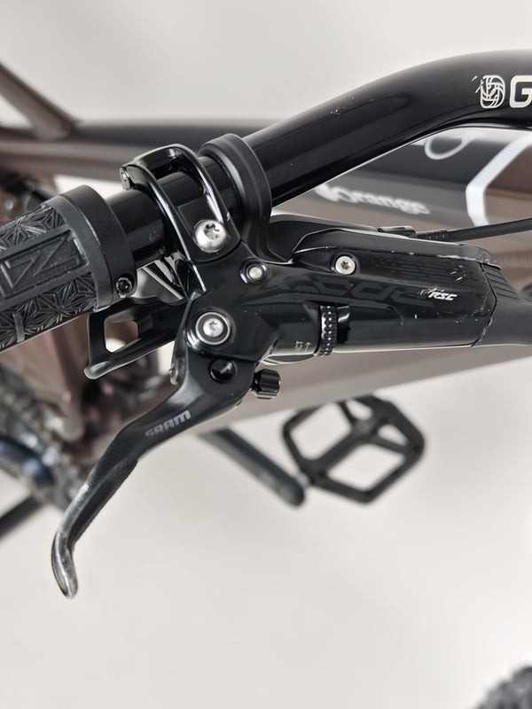 Rear view of the Orange ALPINE 6 Full Suspension Mountain Bike, emphasizing the sturdy components.