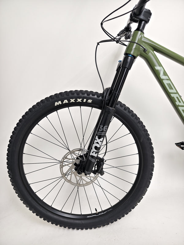 Norco Sight A2 2021 bike standing next to a mountain, emphasizing its mountain biking capabilities.