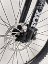Action-oriented shot of a rider on the Norco Sight A2 2021 mountain bike navigating rough terrain.