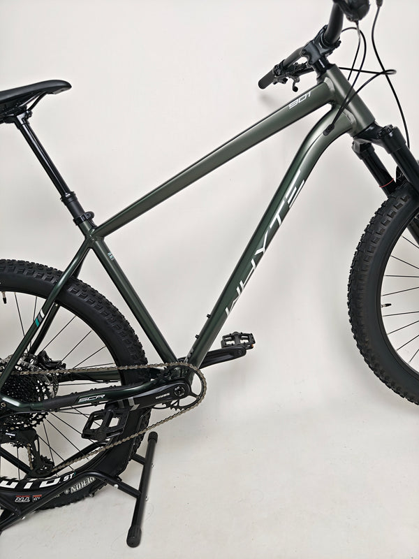 The Whyte 901 V4 2022 Mountain Bike poised in nature, showing off its ability to tackle outdoor trails.