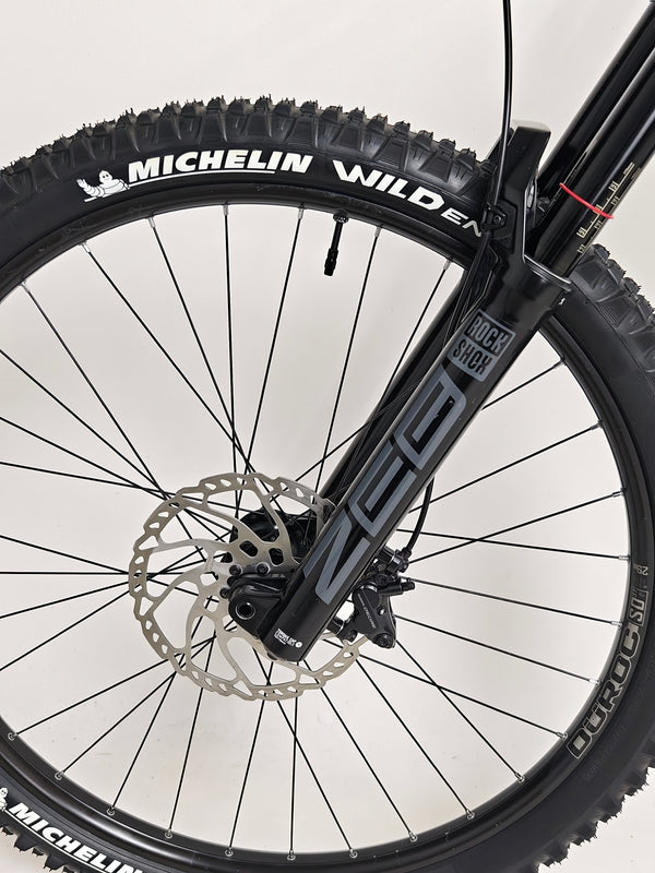 Nukeproof Giga 290 Comp Carbon 2022 mountain bike captured during a thrilling ride.