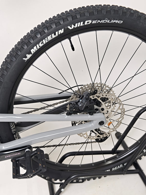 Nukeproof Giga 290 Comp Carbon 2022 bike alongside a mountainous background.