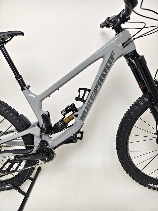 Action shot of the Nukeproof Giga 290 Comp Carbon 2022 bike on a dirt track.