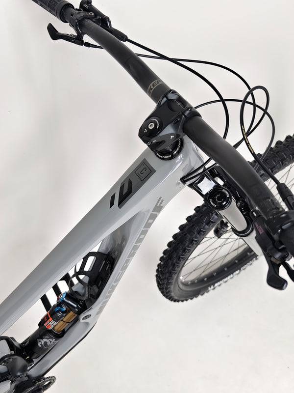 Action shot of the Nukeproof Giga 290 Comp Carbon 2022 tackling a downhill path.