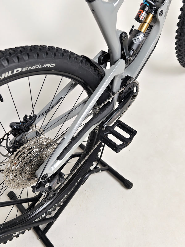 Nukeproof Giga 290 Comp Carbon 2022 mountain bike riding on a forest trail.