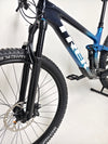 Trek Top Fuel 9.7 2022 CARBON mountain bike demonstrated in action on a trail, perfect for any adventurous rider.