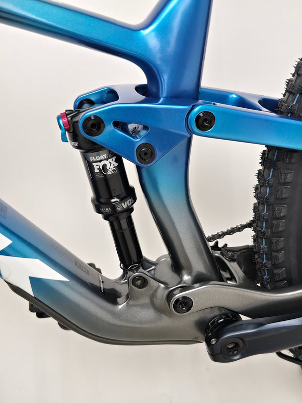 Showing the setup of the Trek Top Fuel 9.7 2022 CARBON bike in a bike shop setting.