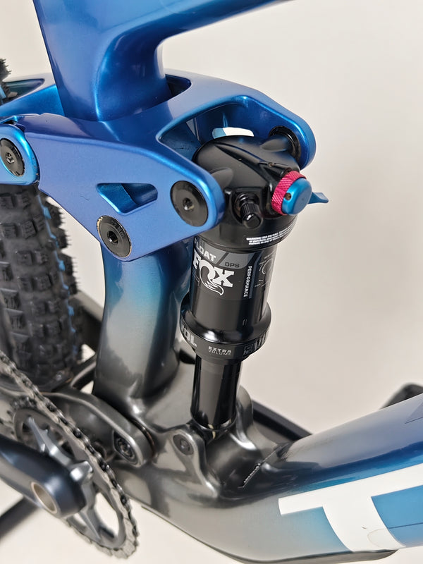 Shiny new Trek Top Fuel 9.7 2022 CARBON bike framed in the foreground against a blurred background.