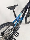 Trek Top Fuel 9.7 2022 CARBON bike set against an outdoor landscape, emphasizing its mountain bike prowess.