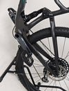 Scott Spark RC 900 Team Issue AXS Carbon bike captured at sunset for aesthetic view.