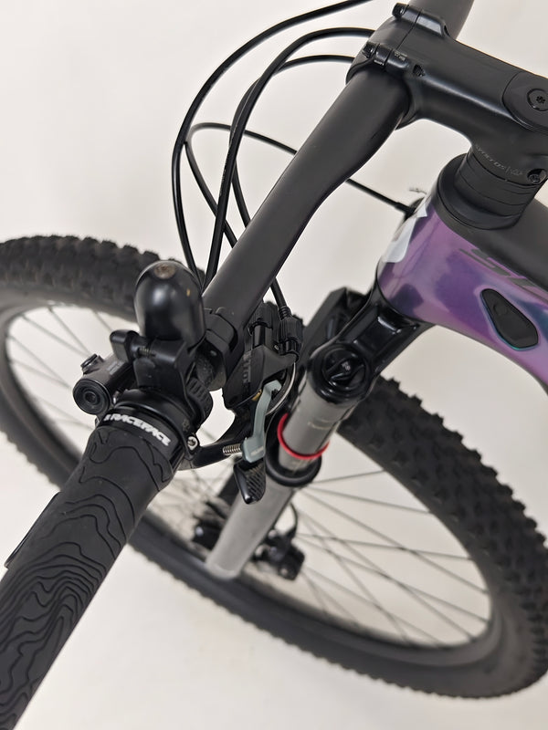 Scott Spark RC 900 Team Issue AXS Carbon bike comfortably positioned in a scenic location.