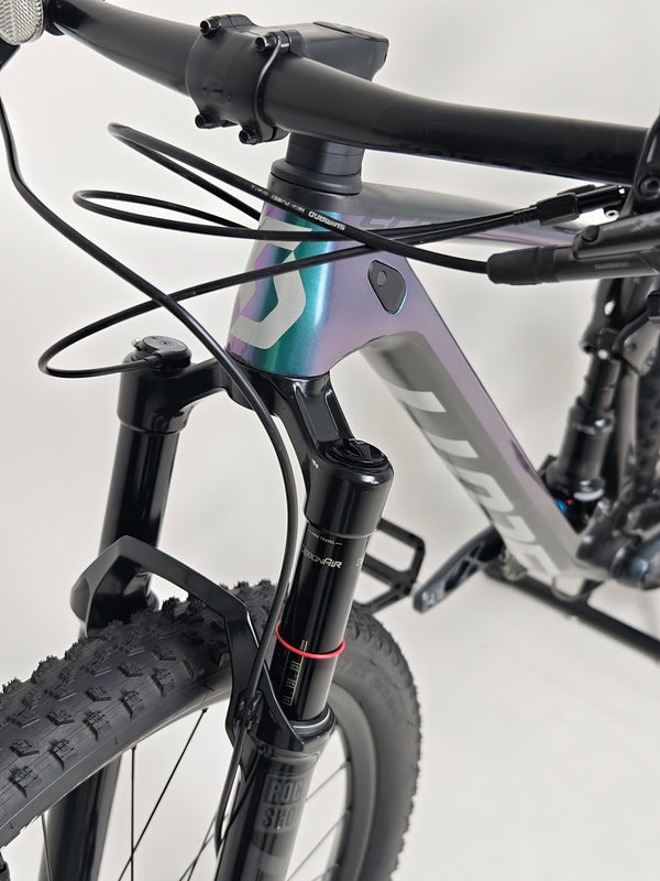 Dramatic view of Scott Spark RC 900 Team Issue AXS Carbon bike under natural lighting.