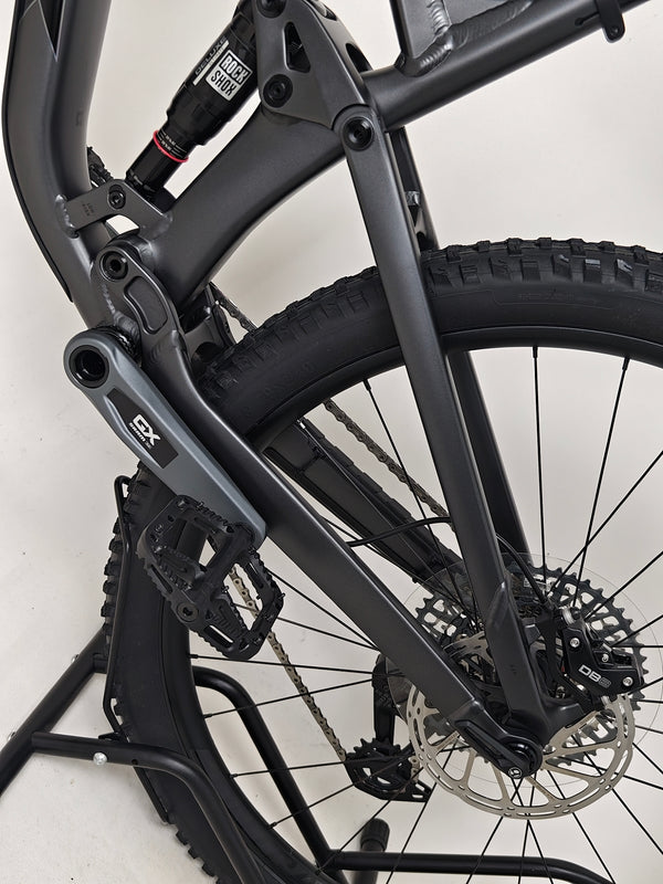 Trek Top Fuel 8 GX AXS 2024 captured while in use on a mountain trail displaying its practical use.