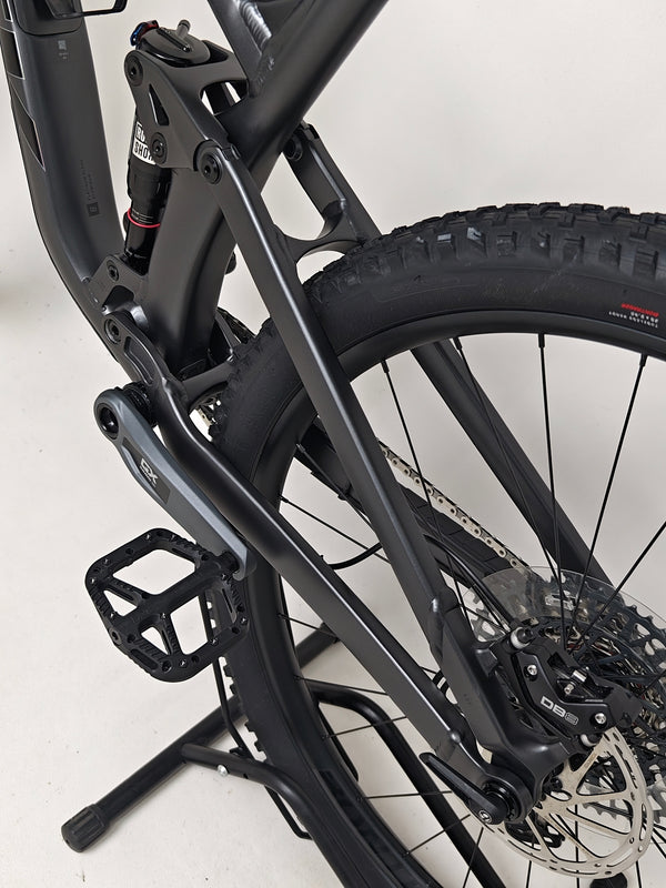 Trek Top Fuel 8 GX AXS 2024 detail of the bike on dirt showcasing its potential in rough terrain.