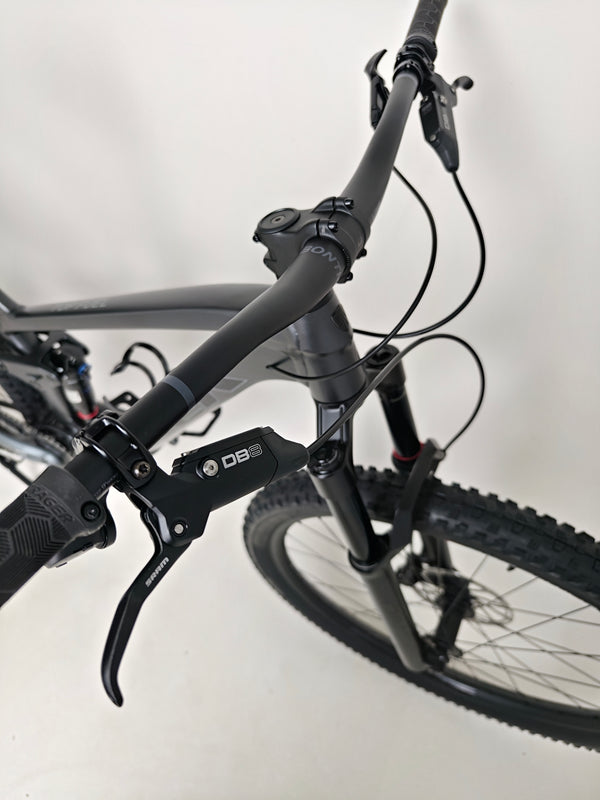 Trek Top Fuel 8 GX AXS 2024 positioned in a standing view to highlight its height and reach.