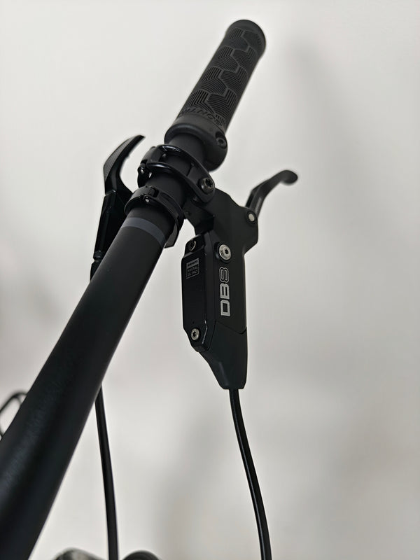 Trek Top Fuel 8 GX AXS 2024 captured while leaning against a wall emphasizing its lightweight frame.