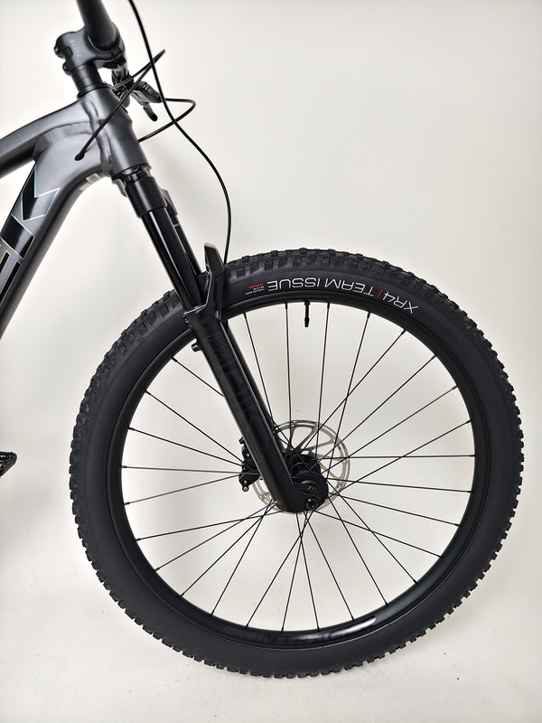 Trek Top Fuel 8 GX AXS 2024 captured in a park with a focus on the bike's premium bikes specs.