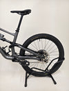 Overview of the Specialized Status 160 with the terrain in the background, representing its mountain biking potential.