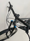 Scenic shot of the Specialized Status 160 on a mountain path highlighting its off-road capabilities.