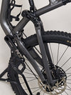 The Specialized Status 160 mountain bike poised on rocky terrain, ready for exploration.