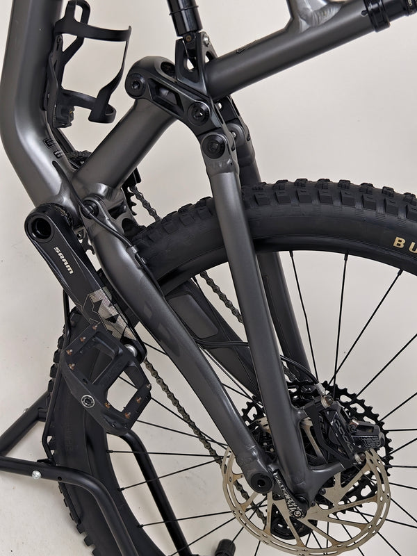 The Specialized Status 160 mountain bike poised on rocky terrain, ready for exploration.