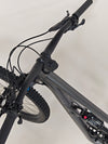 The Specialized Status 160 mountain bike captured in action, showcasing performance on rocky trails.