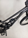 The Specialized Status 160 with rider on a steep hill demonstrating its climbing ability.