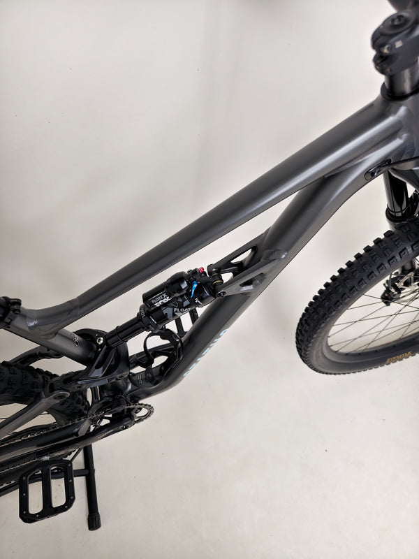 The Specialized Status 160 with rider on a steep hill demonstrating its climbing ability.