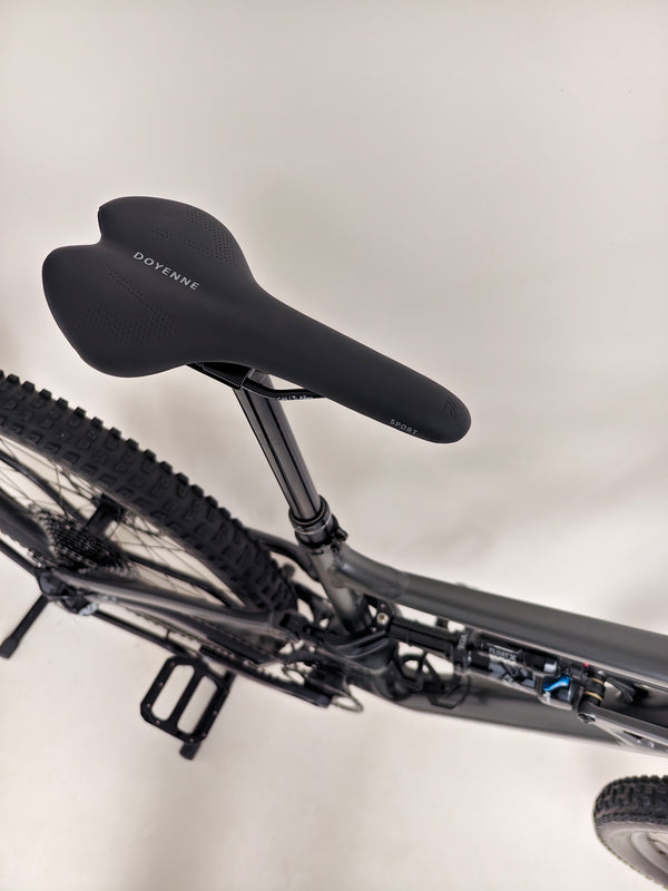 Action shot of a rider on the Specialized Status 160 navigating through a rugged trail.